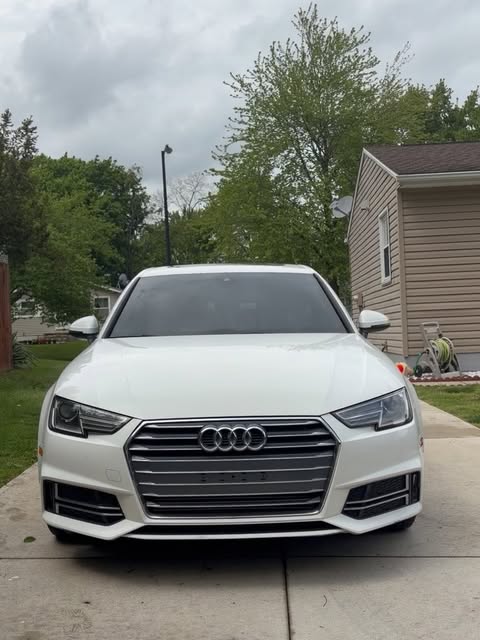 White Audi sedan freshly detailed in a driveway