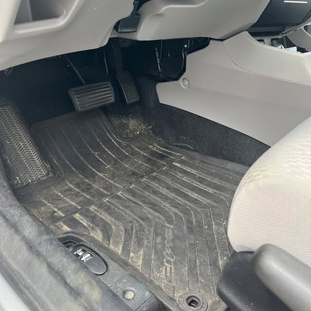 Dirty carpet and floor pan before detailing
