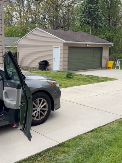 Sedan with doors open mid-detail in a driveway
